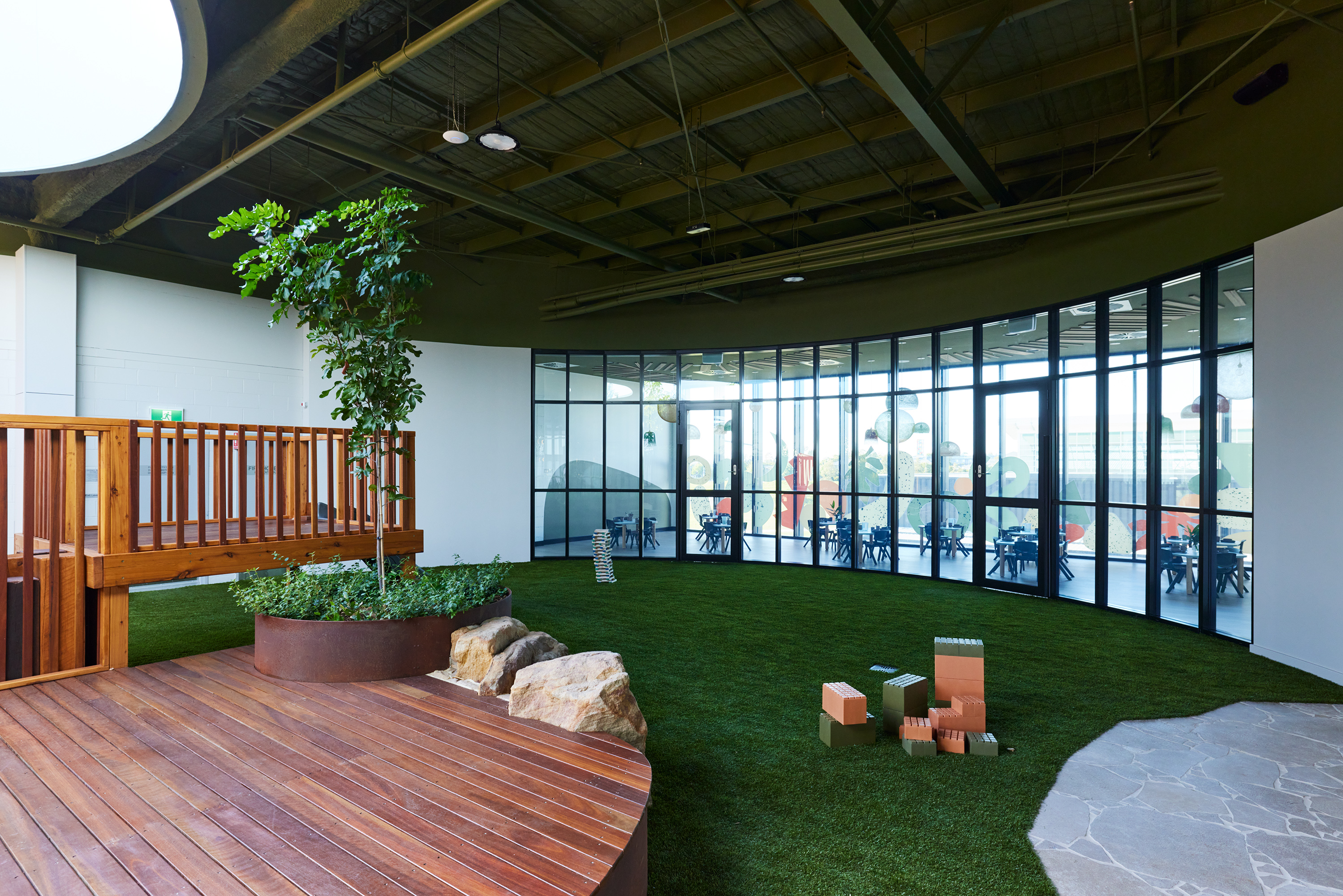 Sandstone boulders and recycled brick planter walls with native plantings