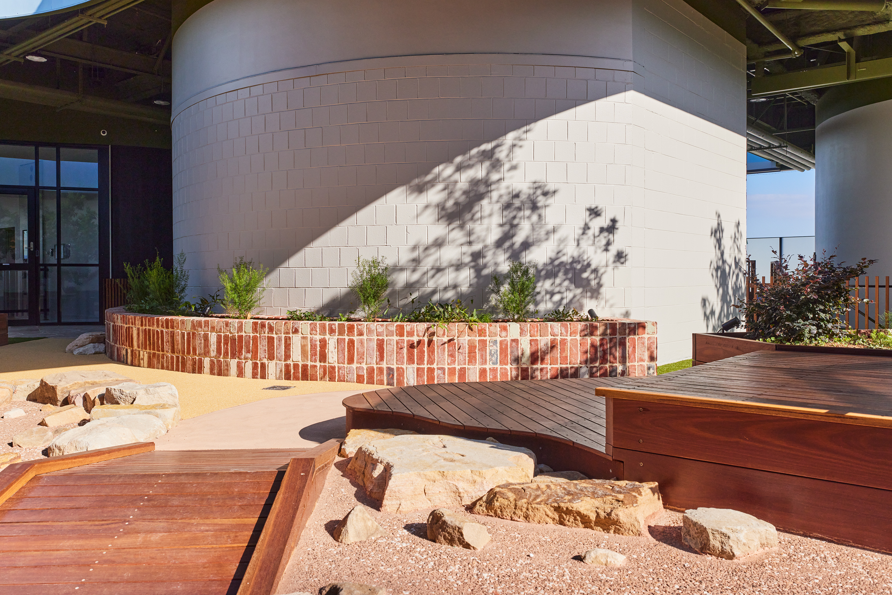 Wide angle of rooftop playground showing multiple play zones and skylights