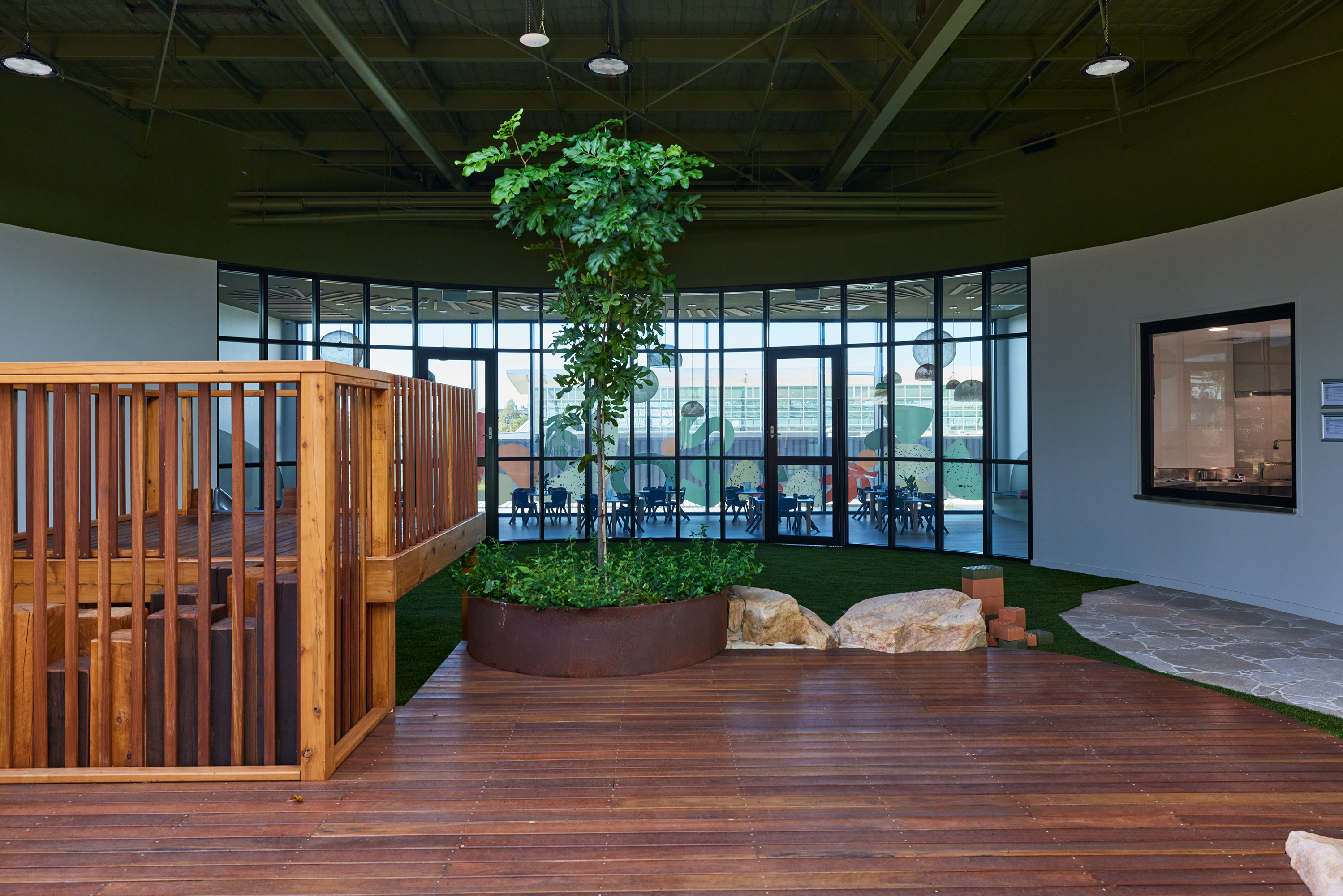 Timber deck platform with corten steel garden beds and tree plantings