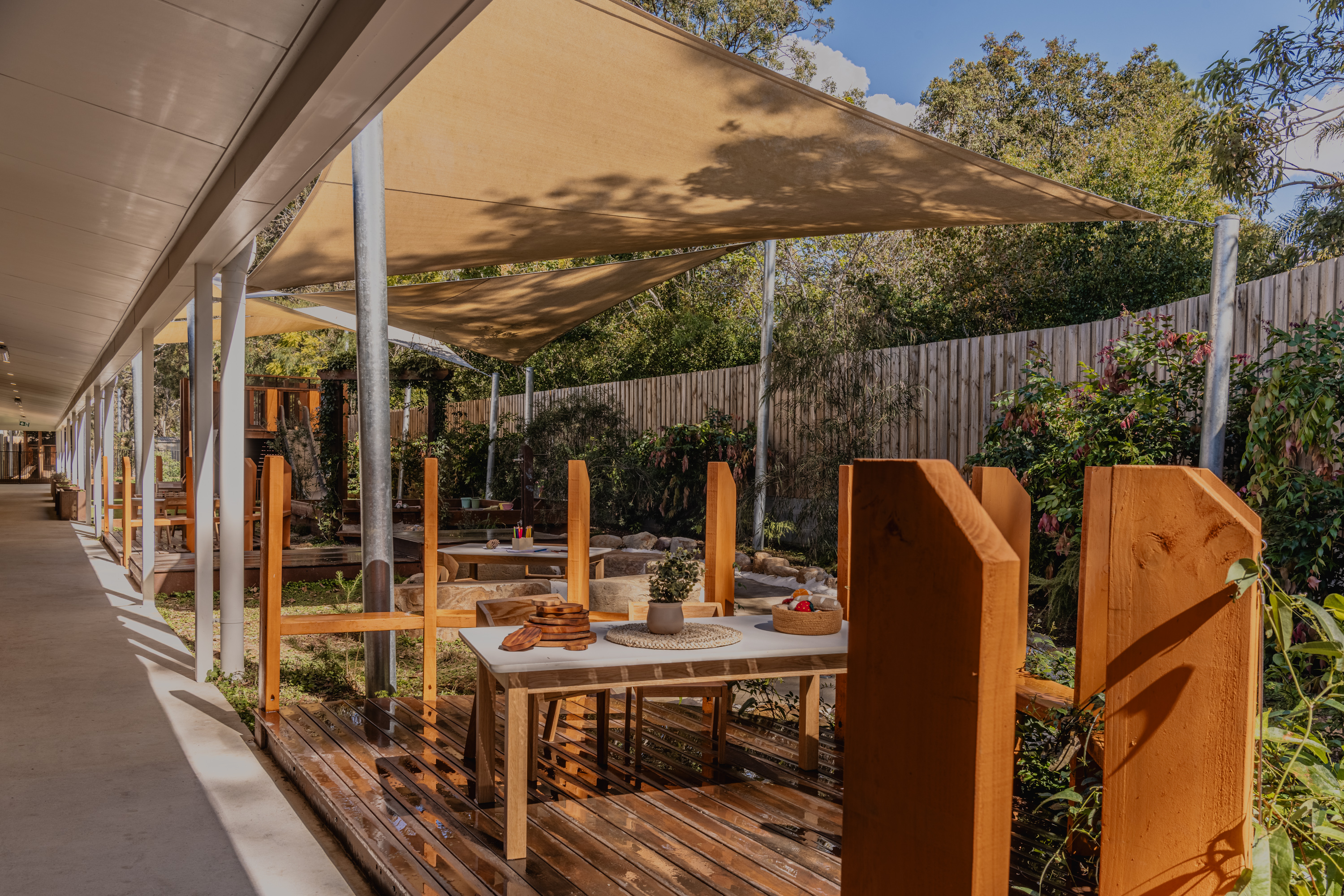 Covered deck and gathering space with sandstone boulders