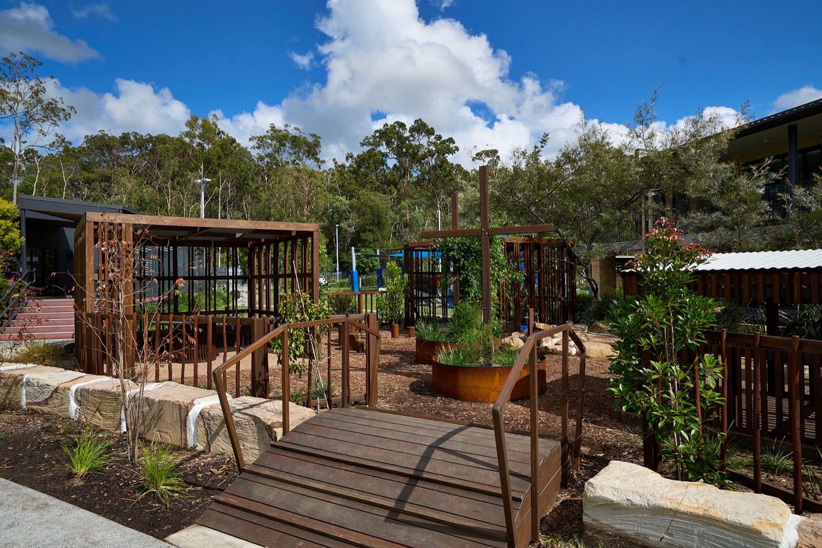 Boardwalk bridge connecting timber play pavilions