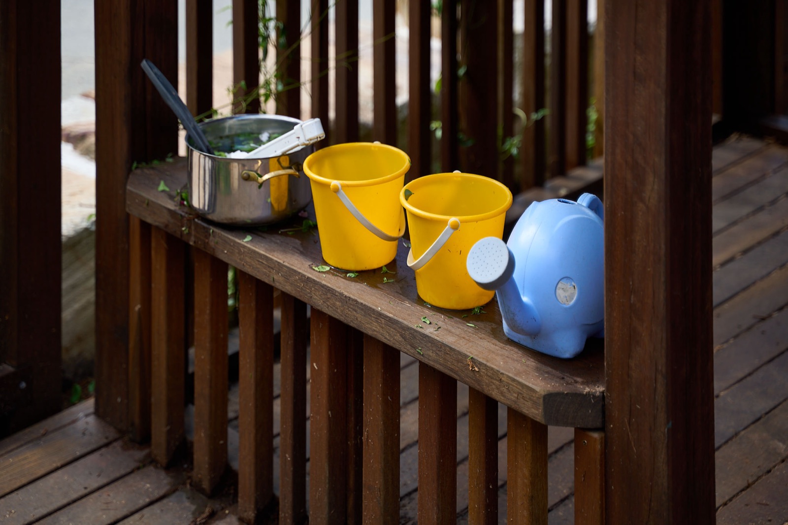 Mud kitchen detail with buckets and pots