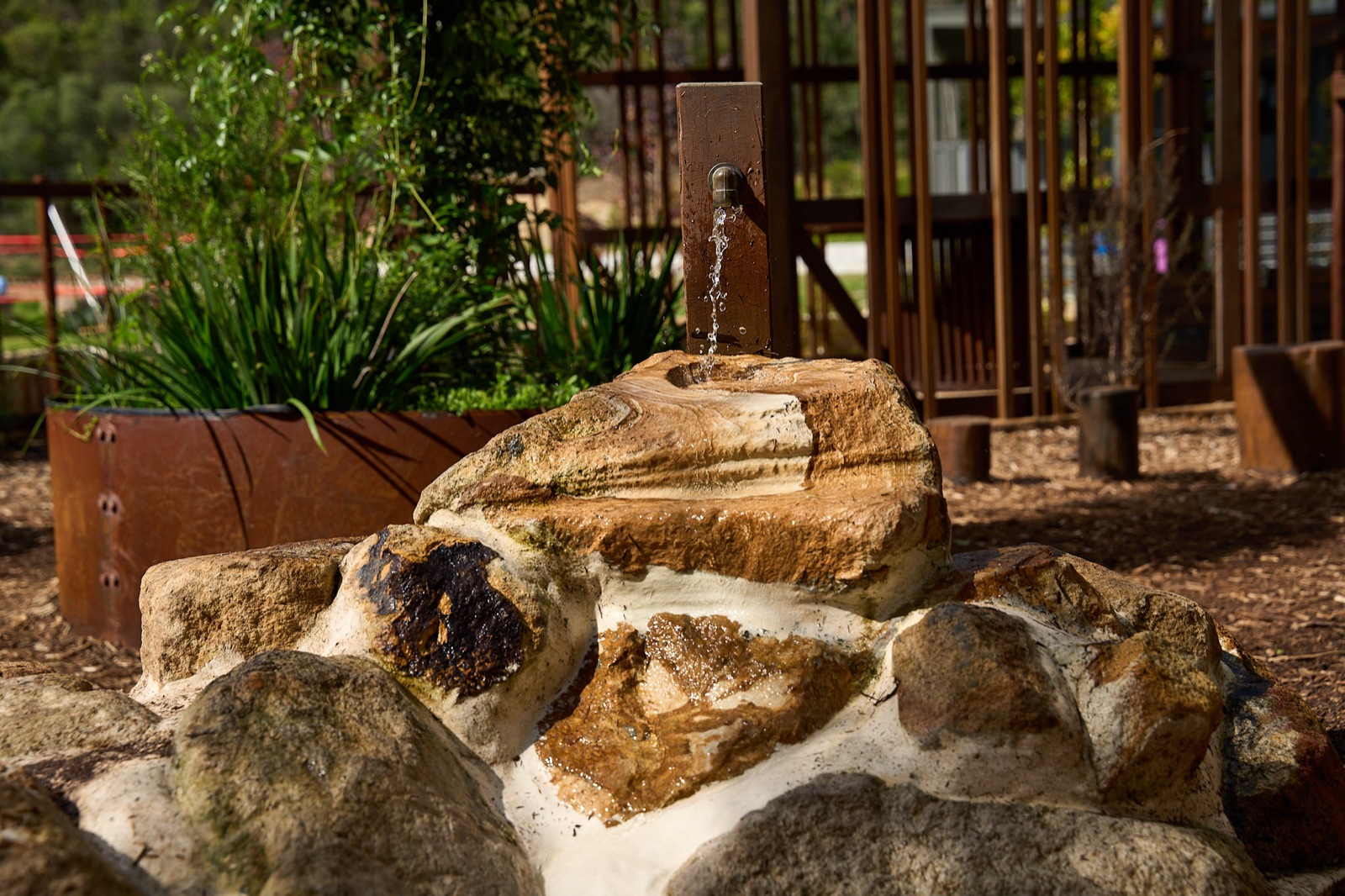 Water feature trickling over natural sandstone rocks