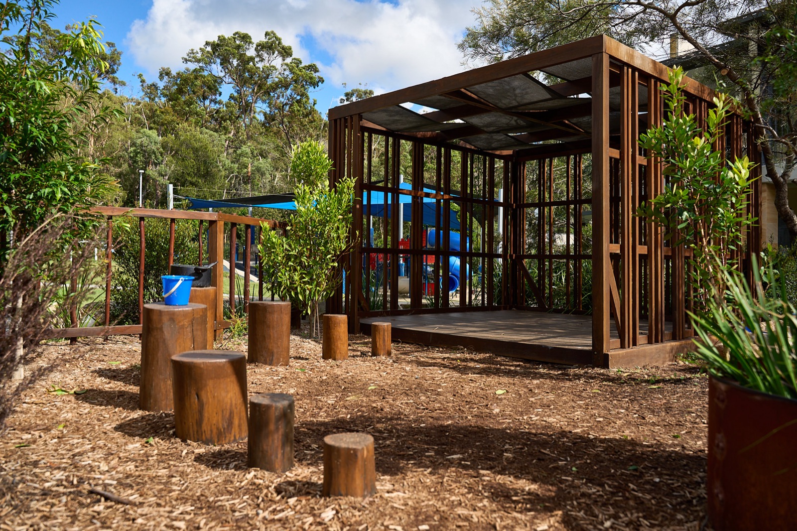 Timber cubby house with log stepping stumps