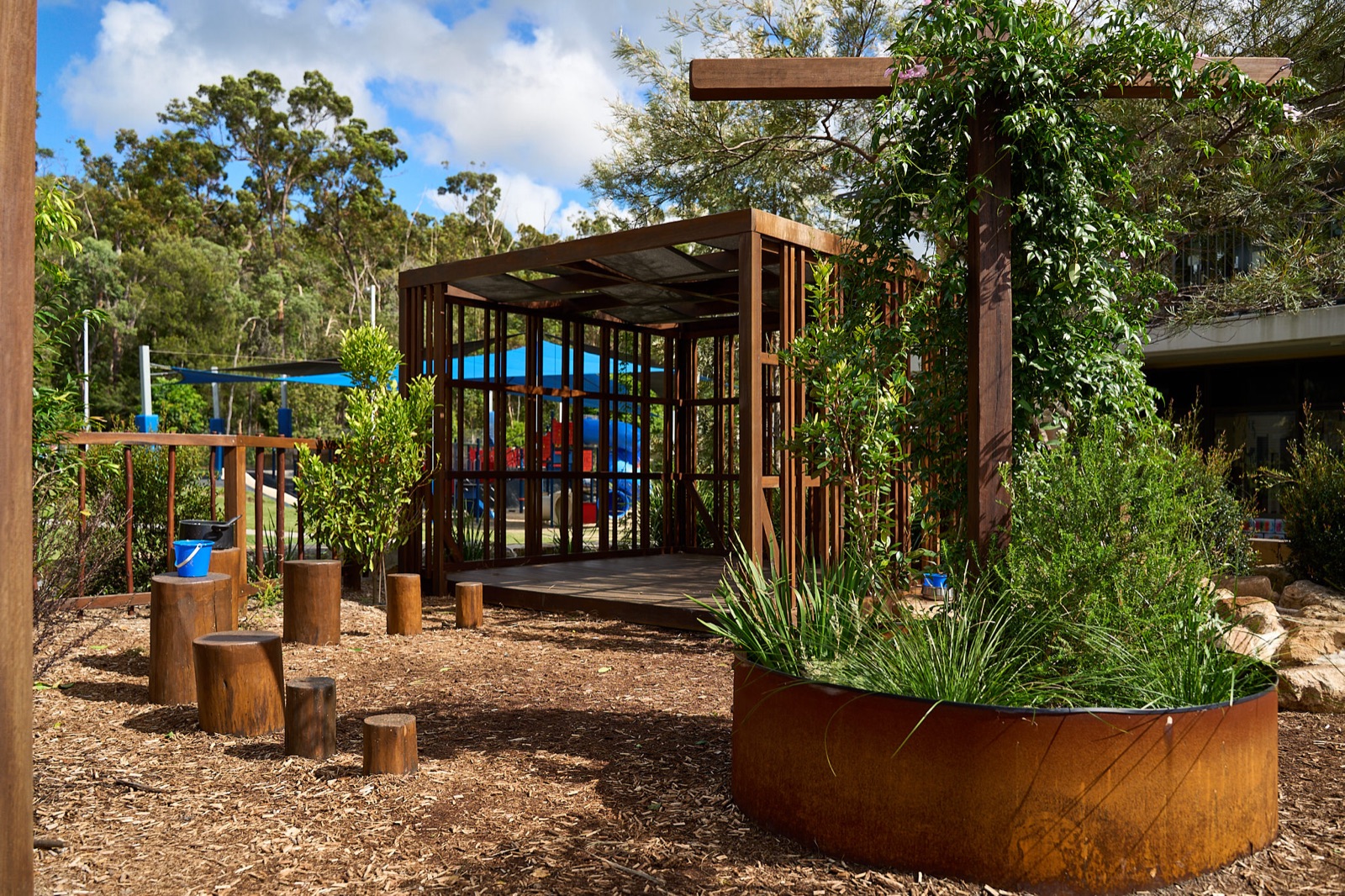 Timber pavilion with corten steel planter and native greenery