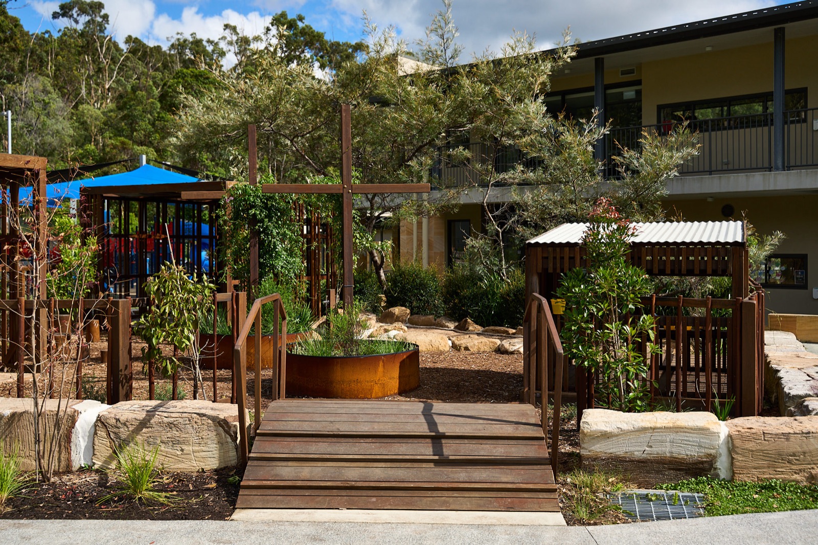 Timber boardwalk bridge entry to the play space
