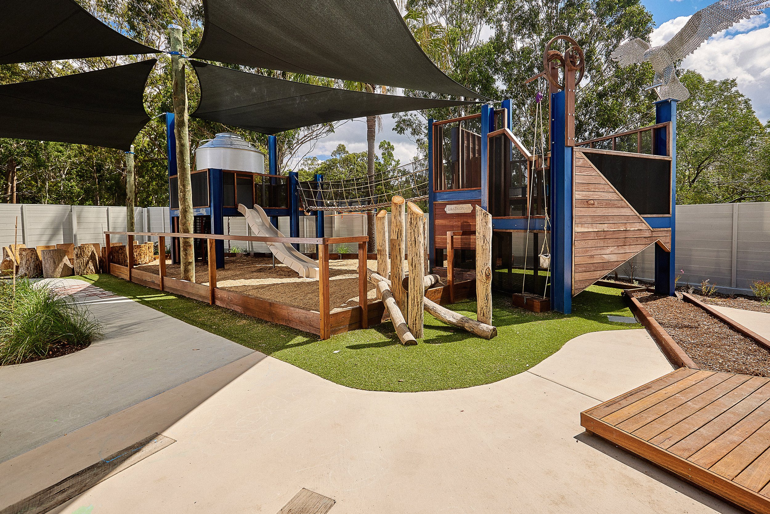 A natural play environment with garden beds and timber