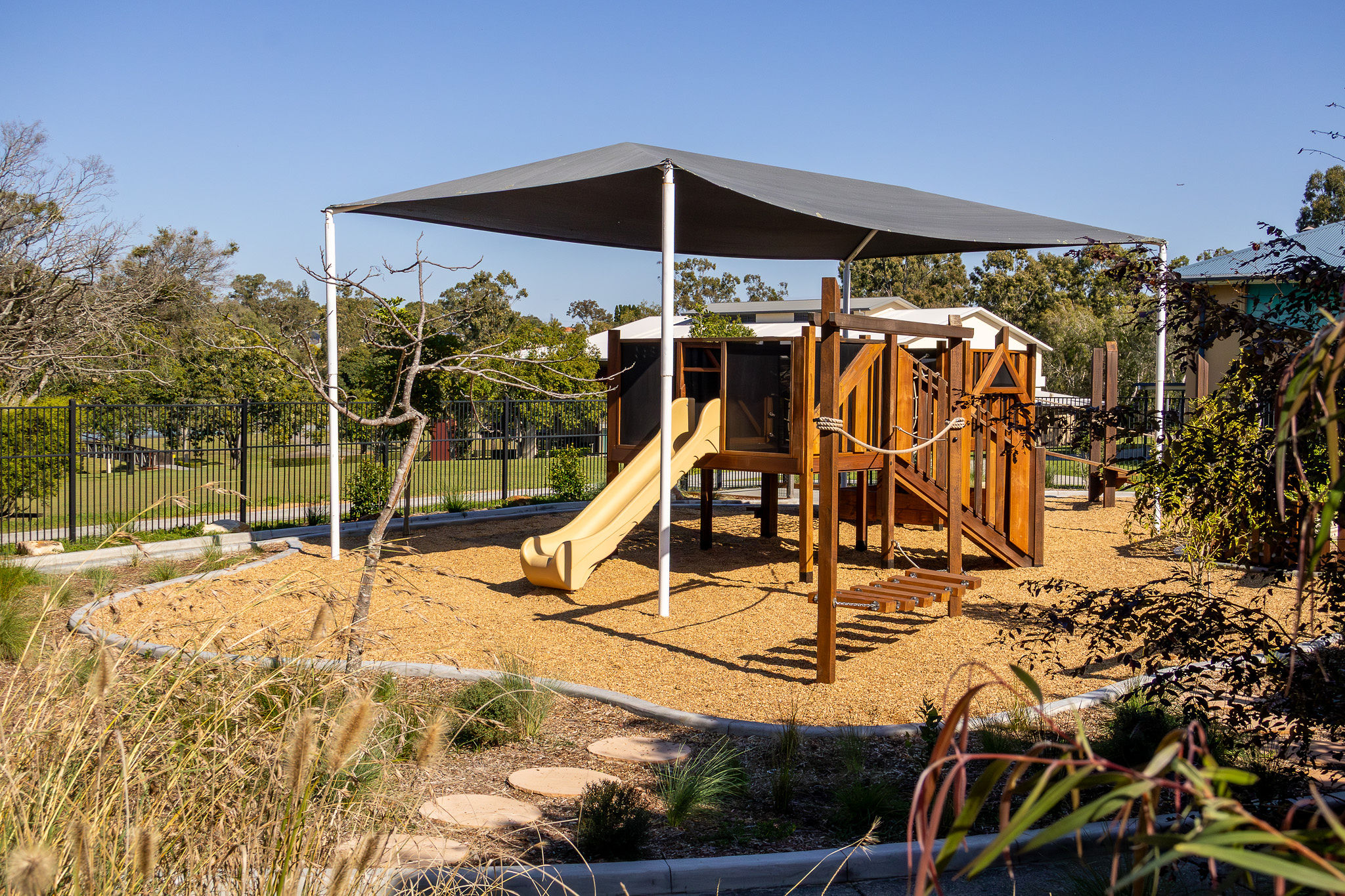 The play tower viewed from the stairs and rope bridge