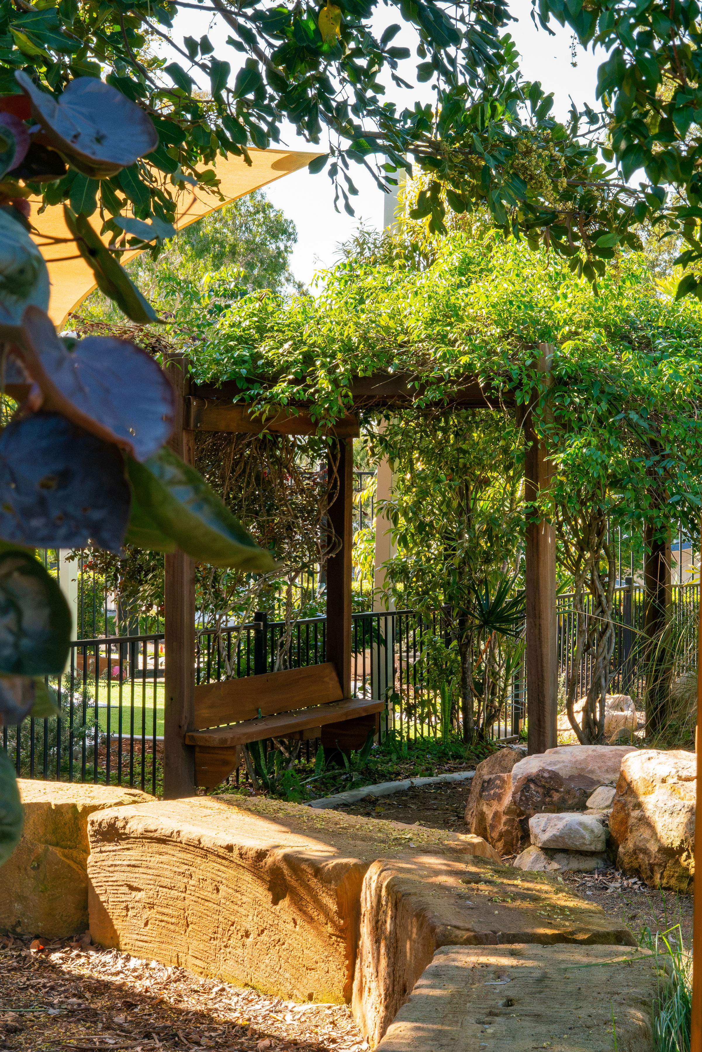 A quiet seating nook beneath the garden pergola