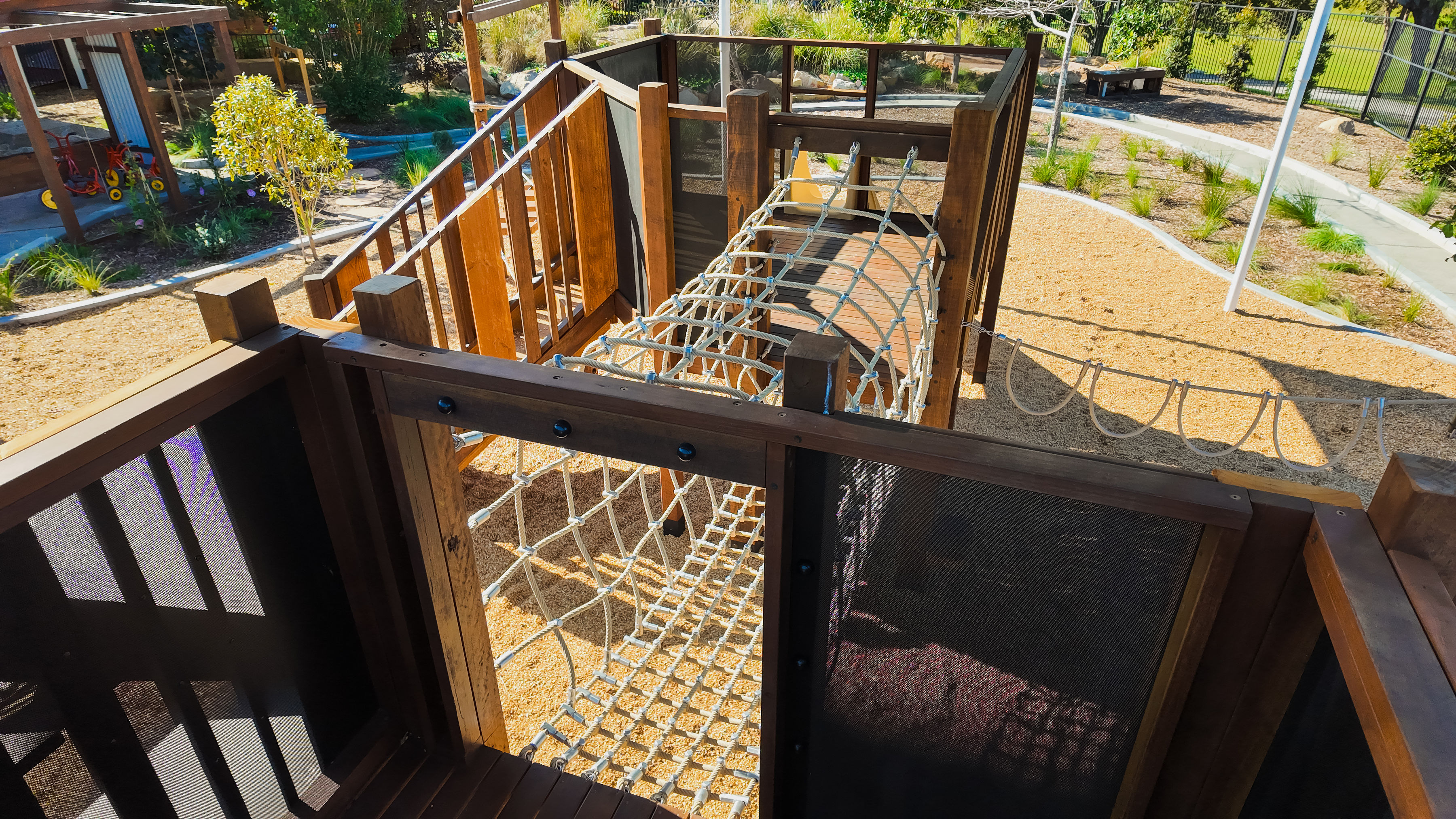 Looking down through the rope tunnel between play towers